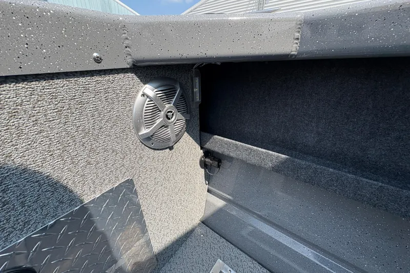 Slide: The Image of Interior of 2026 Lund 185 HG boat featuring speaker and textured surfaces. - 27