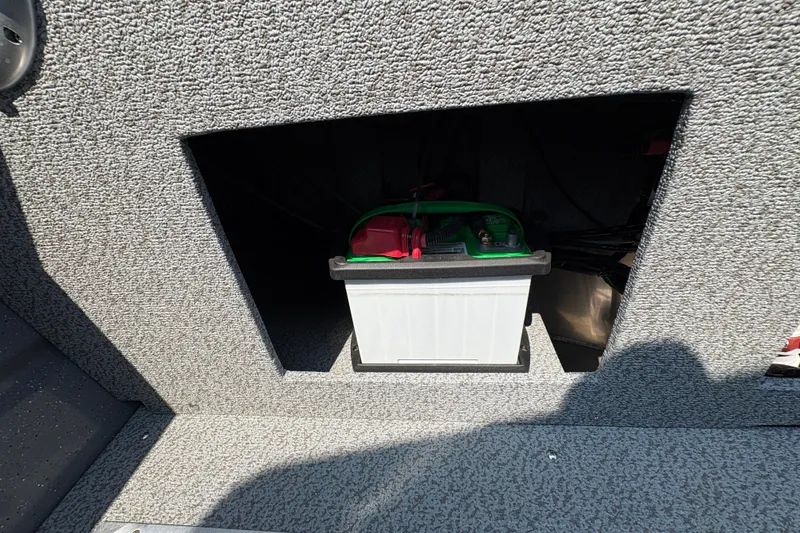 Slide: The Image of Battery compartment in 2026 Lund 185 HG boat, featuring a securely installed battery. - 30