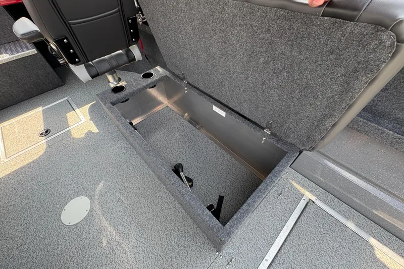 Slide: The Image of Open storage compartment in 2026 Lund 185 HG boat interior, featuring carpeted flooring and seating. - 36