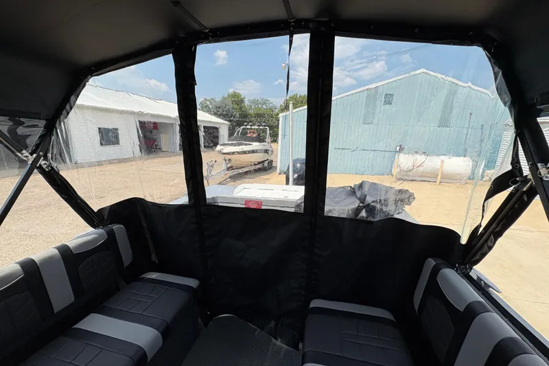Slide: The Image of Interior view of 2026 Lund 185 HG boat with black seating and clear canopy. - 38