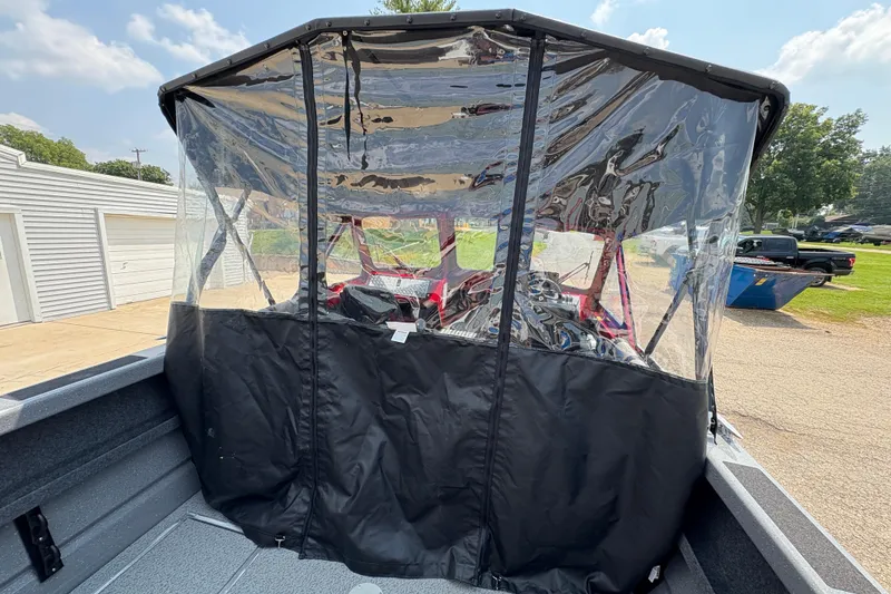 Slide: The Image of 2026 Lund 185 HG boat with clear protective canopy in a sunny outdoor setting. - 39