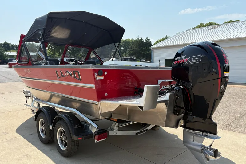 Slide: The Image of 2026 Lund 185 HG boat with Mercury Pro XS engine, parked on a trailer. - 4
