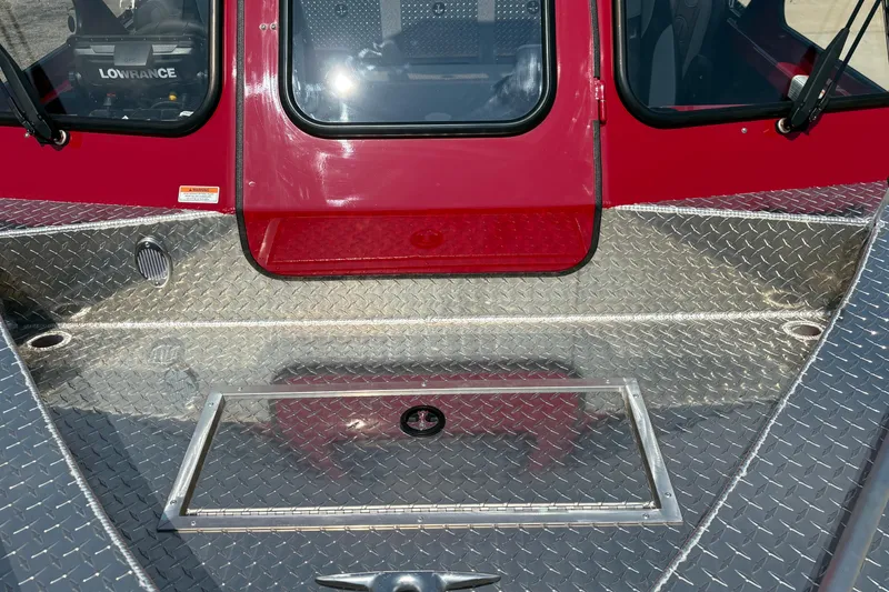 Slide: The Image of 2026 Lund 185 HG boat with red cabin and diamond plate deck. - 9