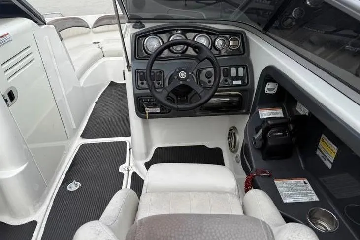 Slide: The Image of 2007 Yamaha AR 230 boat cockpit with steering wheel and control panel. - 11