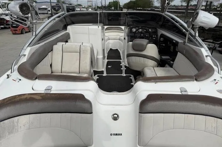 Slide: The Image of 2007 Yamaha AR 230 boat interior with seating and dashboard, featuring white and brown upholstery. - 14