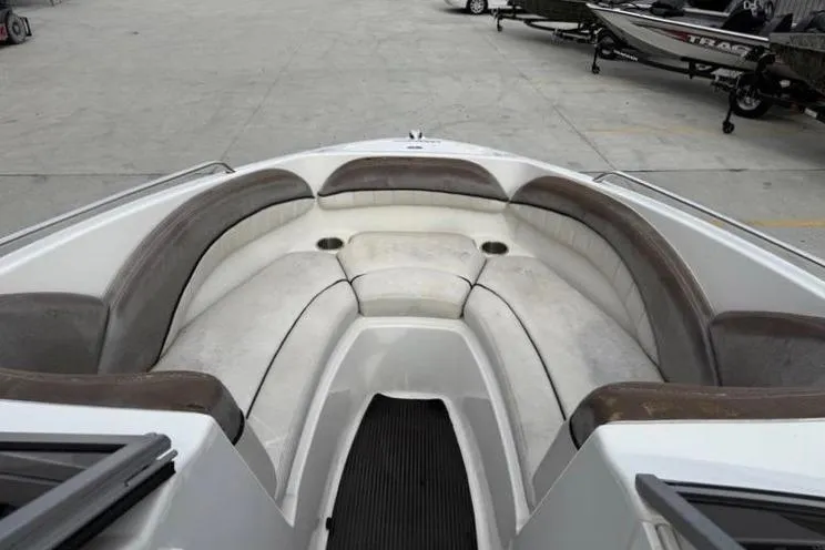 Slide: The Image of 2007 Yamaha AR 230 boat interior with cushioned seating and cup holders. - 15