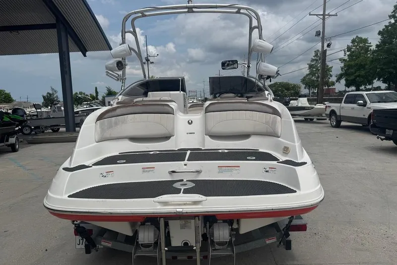 Slide: The Image of 2007 Yamaha AR 230 boat with dual seating, parked outdoors on a trailer. - 3