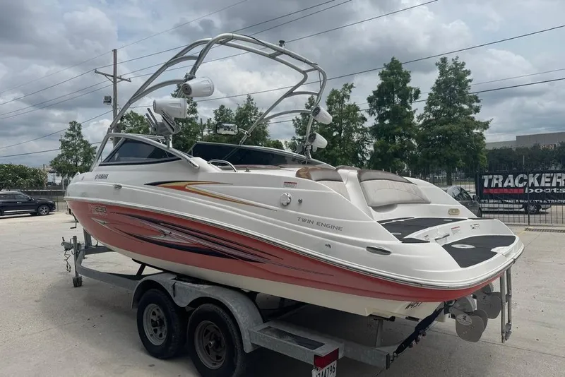 Slide: The Image of 2007 Yamaha AR 230 boat on trailer, twin engine, sleek design, outdoor setting. - 4