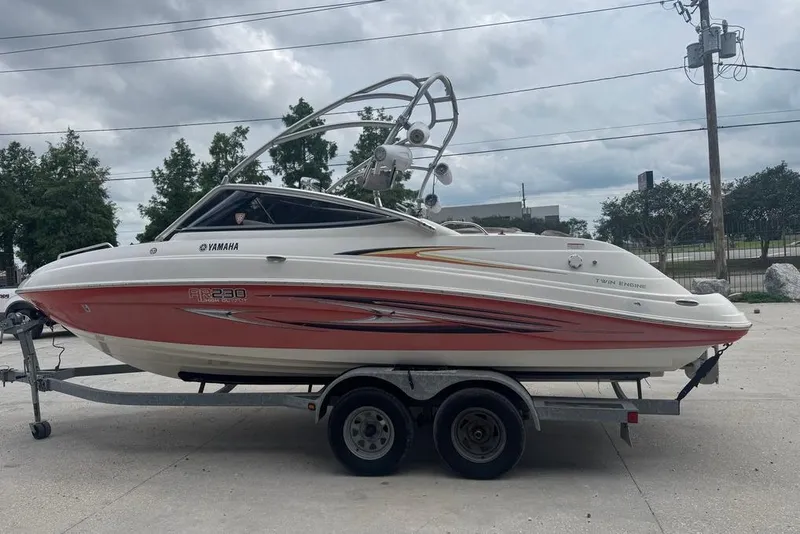 Slide: The Image of 2007 Yamaha AR 230 boat on trailer, parked outdoors under cloudy sky. - 8