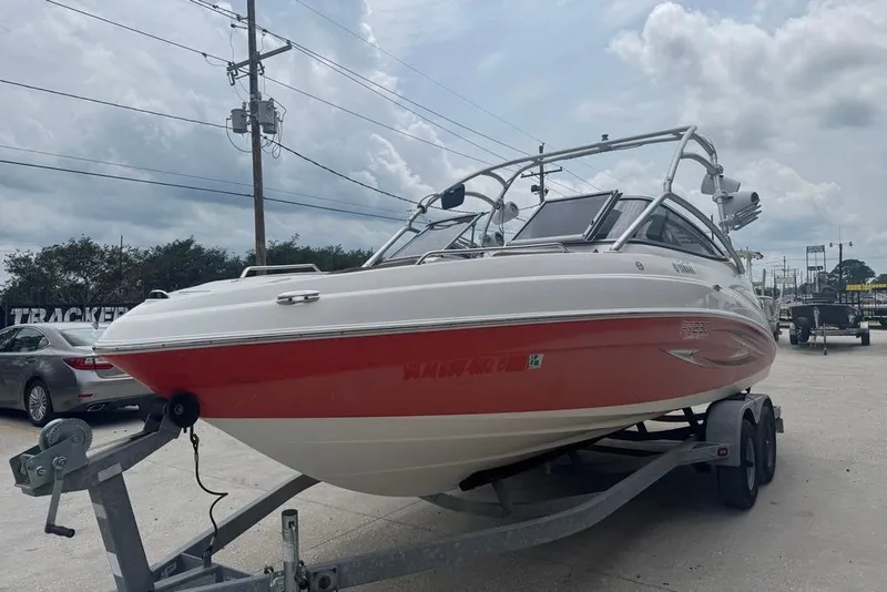 Slide: The Image of 2007 Yamaha AR 230 boat on trailer, red and white design, parked outdoors. - 9