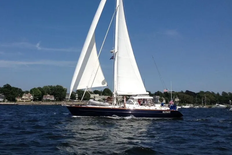 Slide: The Image of Sailing yacht Tayana 58, 1996 model, cruising on a sunny day near the coastline. - 1