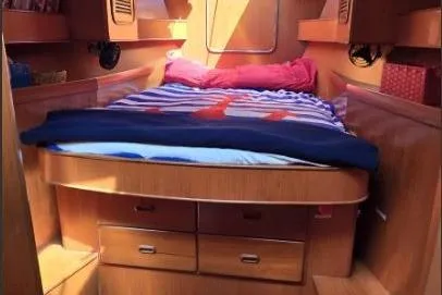 Slide: The Image of Cozy cabin interior of 1996 Tayana 58 yacht with wooden furnishings and a comfortable bed. - 15