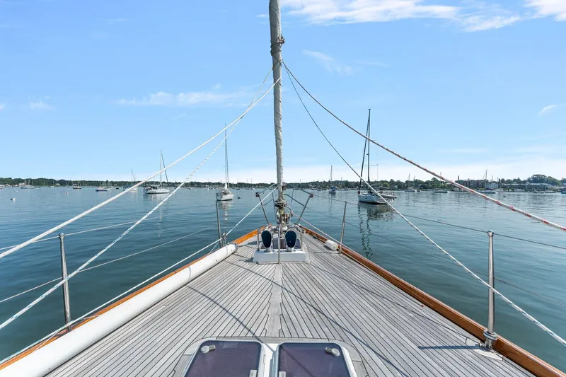 Slide: The Image of Deck view of 1996 Tayana 58 sailboat on calm waters with clear sky. - 20