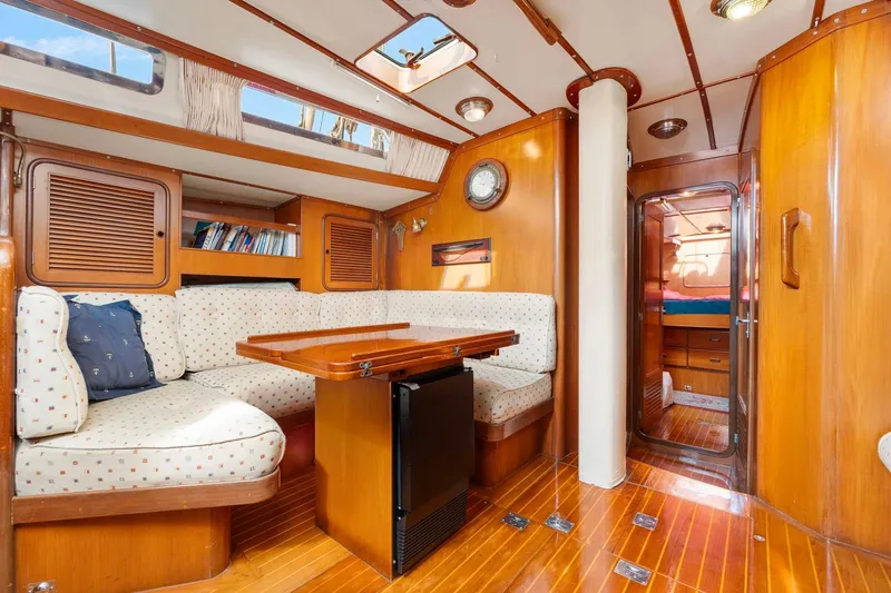 Slide: The Image of Interior of 1996 Tayana 58 yacht with cozy seating and wooden finishes. - 6