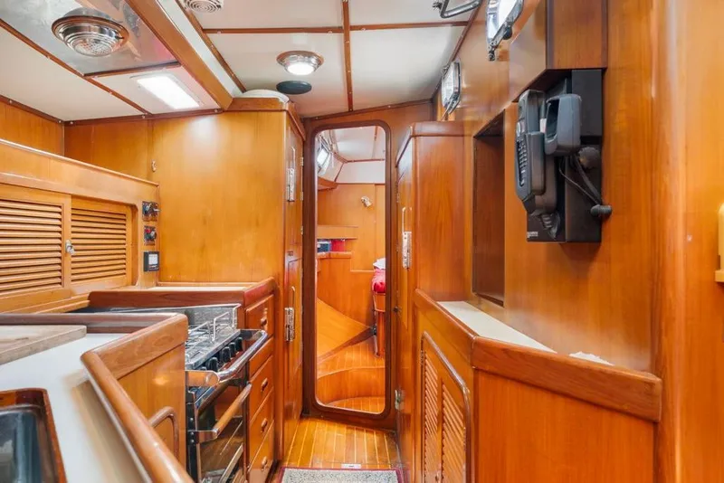 Slide: The Image of Interior of 1996 Tayana 58 yacht with wooden cabinetry and modern amenities. - 8