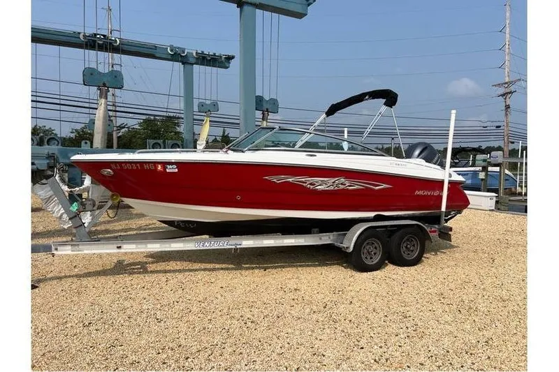 Slide: The Image of 2015 Monterey 217 Blackfin boat on trailer, red and white design, parked outdoors. - 1