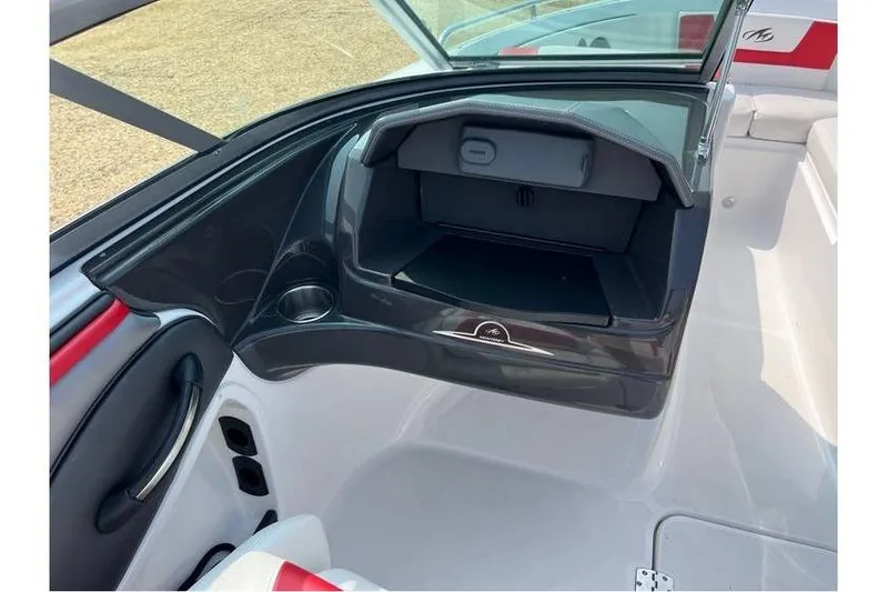 Slide: The Image of 2015 Monterey 217 Blackfin boat interior with open glove compartment and cup holder. - 10