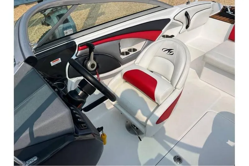 Slide: The Image of 2015 Monterey 217 Blackfin boat interior with red and white seating and steering wheel. - 12