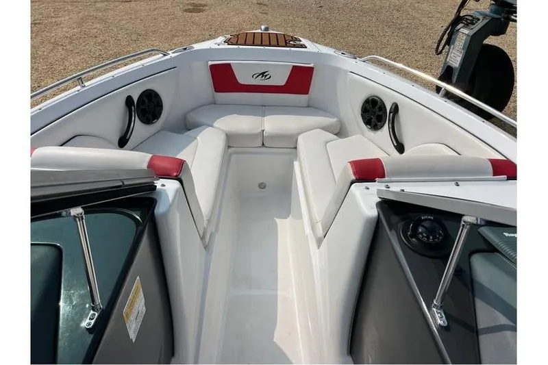Slide: The Image of 2015 Monterey 217 Blackfin boat interior with white and red seating, speakers, and steering wheel. - 17