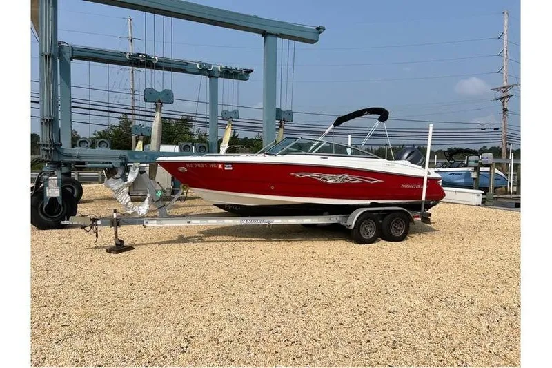 Slide: The Image of 2015 Monterey 217 Blackfin boat on trailer, red and white design, parked outdoors. - 2