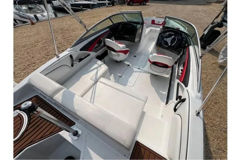 Slide: The Image of 2015 Monterey 217 Blackfin boat interior with white seating and modern dashboard. - 20