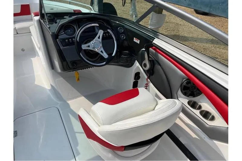 Slide: The Image of 2015 Monterey 217 Blackfin boat interior with steering wheel and red-accented seating. - 8