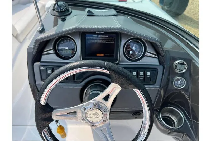 Slide: The Image of Dashboard of 2015 Monterey 217 Blackfin boat with steering wheel and gauges. - 9