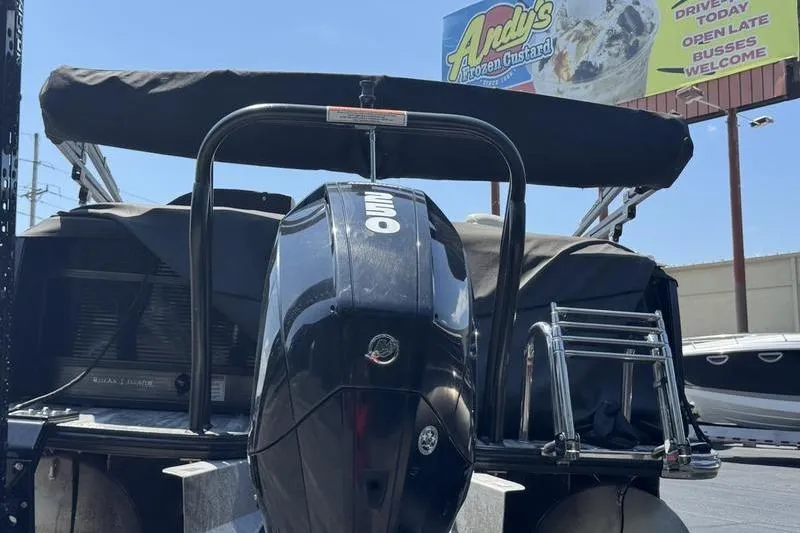 Slide: The Image of 2020 Crest Caribbean LX 250 SLC boat with outboard motor, parked near Andy's Frozen Custard sign. - 10