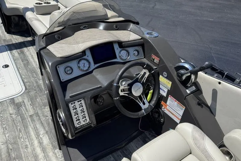 Slide: The Image of 2020 Crest Caribbean LX 250 SLC boat dashboard with steering wheel and controls. - 13