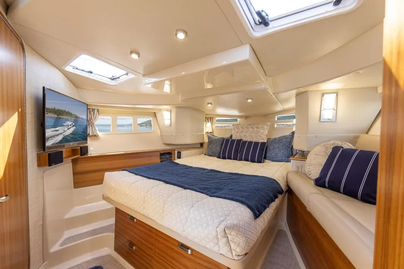 Slide: The Image of Luxurious interior of 2025 Ranger Tugs R-43 S yacht with cozy bedroom and modern amenities. - 12