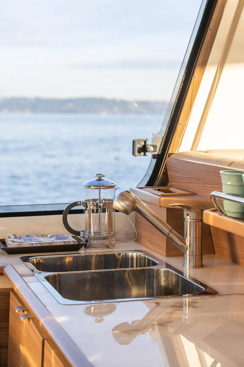 Slide: The Image of Modern kitchen in 2025 Ranger Tugs R-43 S yacht with ocean view. - 17