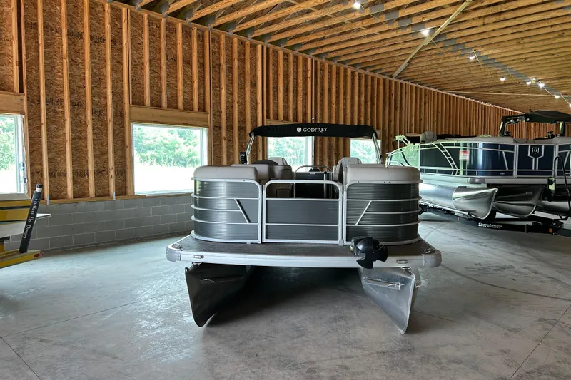 Slide: The Image of 2023 Godfrey SWEETWATER 2286 SB pontoon boat in a wooden storage facility. - 3