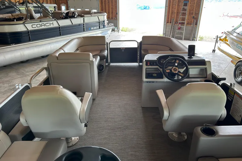 Slide: The Image of Interior view of 2023 Godfrey SWEETWATER 2286 SB pontoon boat in a garage. - 5