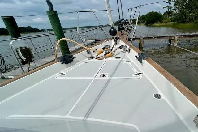 Slide: The Image of Sailboat deck of 2016 Gozzard 41 RC docked by a serene waterfront. - 11