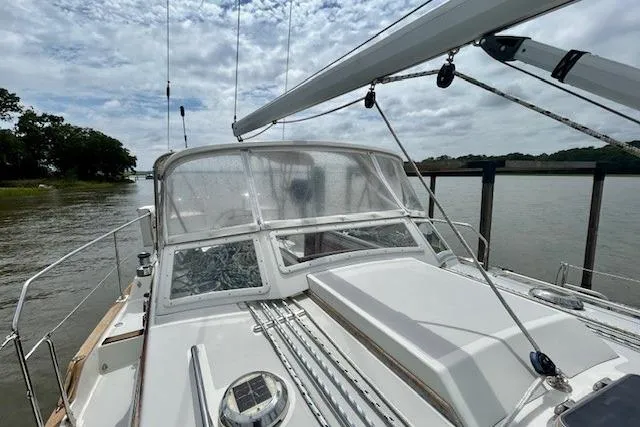 Slide: The Image of Sailboat Gozzard 41 RC, 2016 model, docked by a river under cloudy skies. - 12