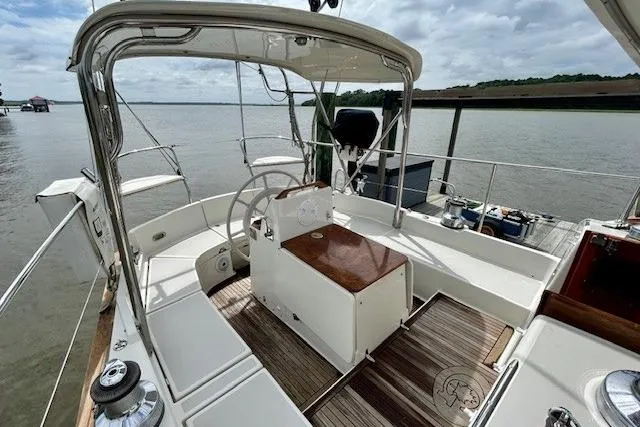 Slide: The Image of 2016 Gozzard 41 RC sailboat cockpit with steering wheel, docked by calm waters. - 13