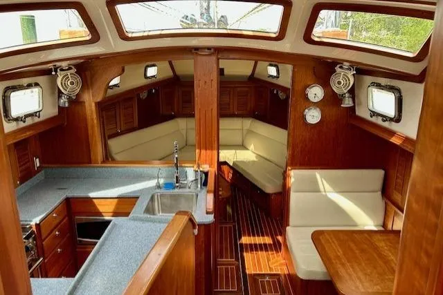 Slide: The Image of Interior of 2016 Gozzard 41 RC sailboat with wood finish and cozy seating area. - 20