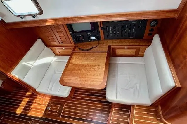Slide: The Image of 2016 Gozzard 41 RC yacht interior with wooden table and cushioned seating. - 22