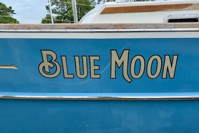 Slide: The Image of Blue Gozzard 41 RC sailboat named "Blue Moon," 2016 model, docked outdoors. - 3