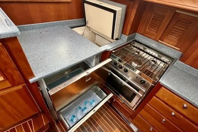 Slide: The Image of Gozzard 41 RC 2016 yacht kitchen with stove, fridge, and freezer. - 32
