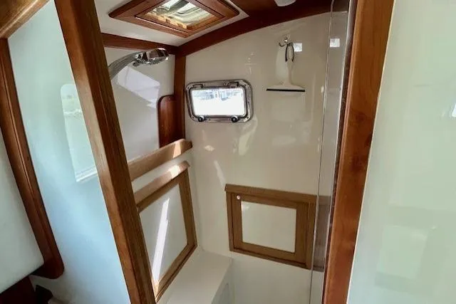 Slide: The Image of Interior of 2016 Gozzard 41 RC yacht bathroom with wooden accents and porthole window. - 34