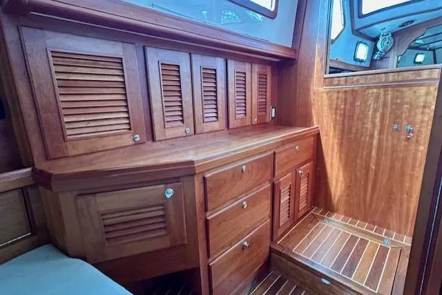 Slide: The Image of Luxurious wooden interior of 2016 Gozzard 41 RC yacht, featuring cabinets and drawers. - 39