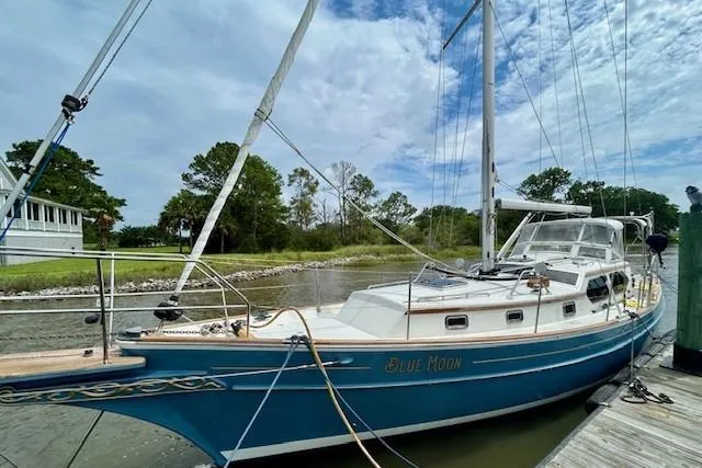 Slide: The Image of 2016 Gozzard 41 RC sailboat "Blue Moon" docked by a scenic shoreline. - 5