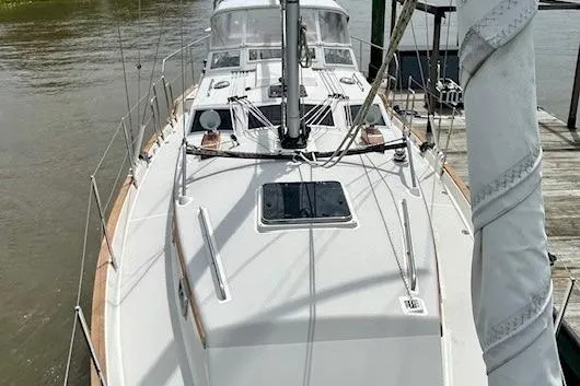 Slide: The Image of 2016 Gozzard 41 RC sailboat docked, showcasing deck and mast. - 8