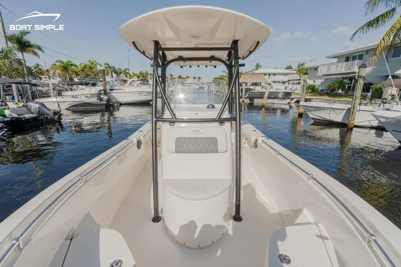 Slide: The Image of 2023 Cobia 220 Center Console boat docked in a marina. - 9