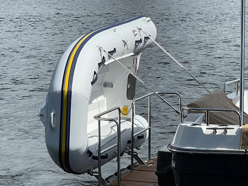 Slide: The Image of 2025 Ranger Tugs R-31S with attached inflatable dinghy on water. - 9