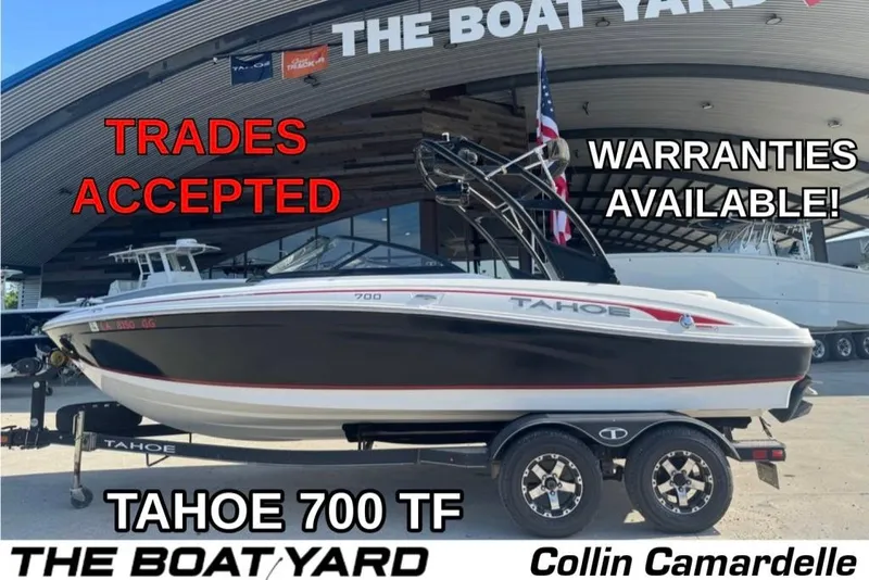 The Image of 2018 Tahoe 700 TF boat at dealership, trades accepted, warranties available, displayed on trailer. - 1