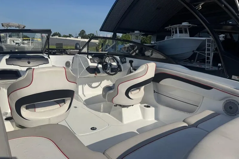 Slide: The Image of Interior of 2018 Tahoe 700 TF boat with white seating and modern dashboard. - 10