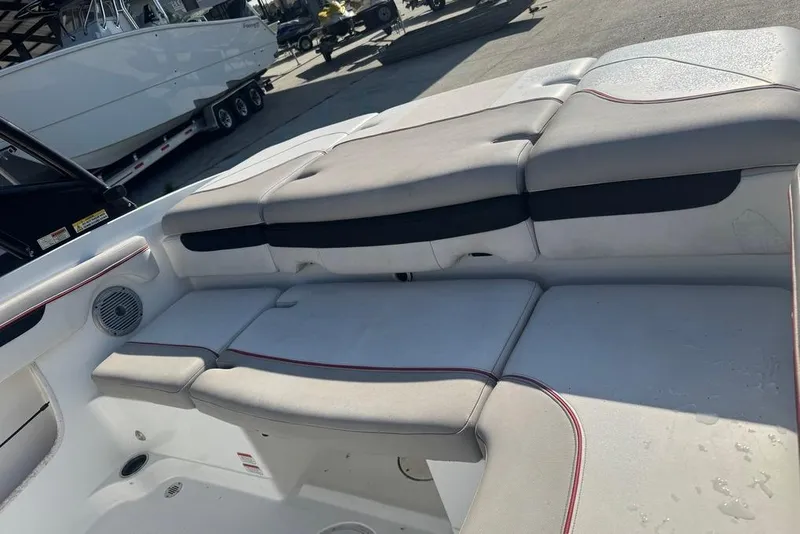 Slide: The Image of 2018 Tahoe 700 TF boat interior with cushioned seating and speaker. - 12