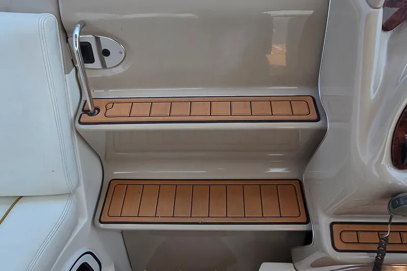 Slide: The Image of 2003 Sea Ray 280 Sundancer boat interior steps with teak-style finish. - 10